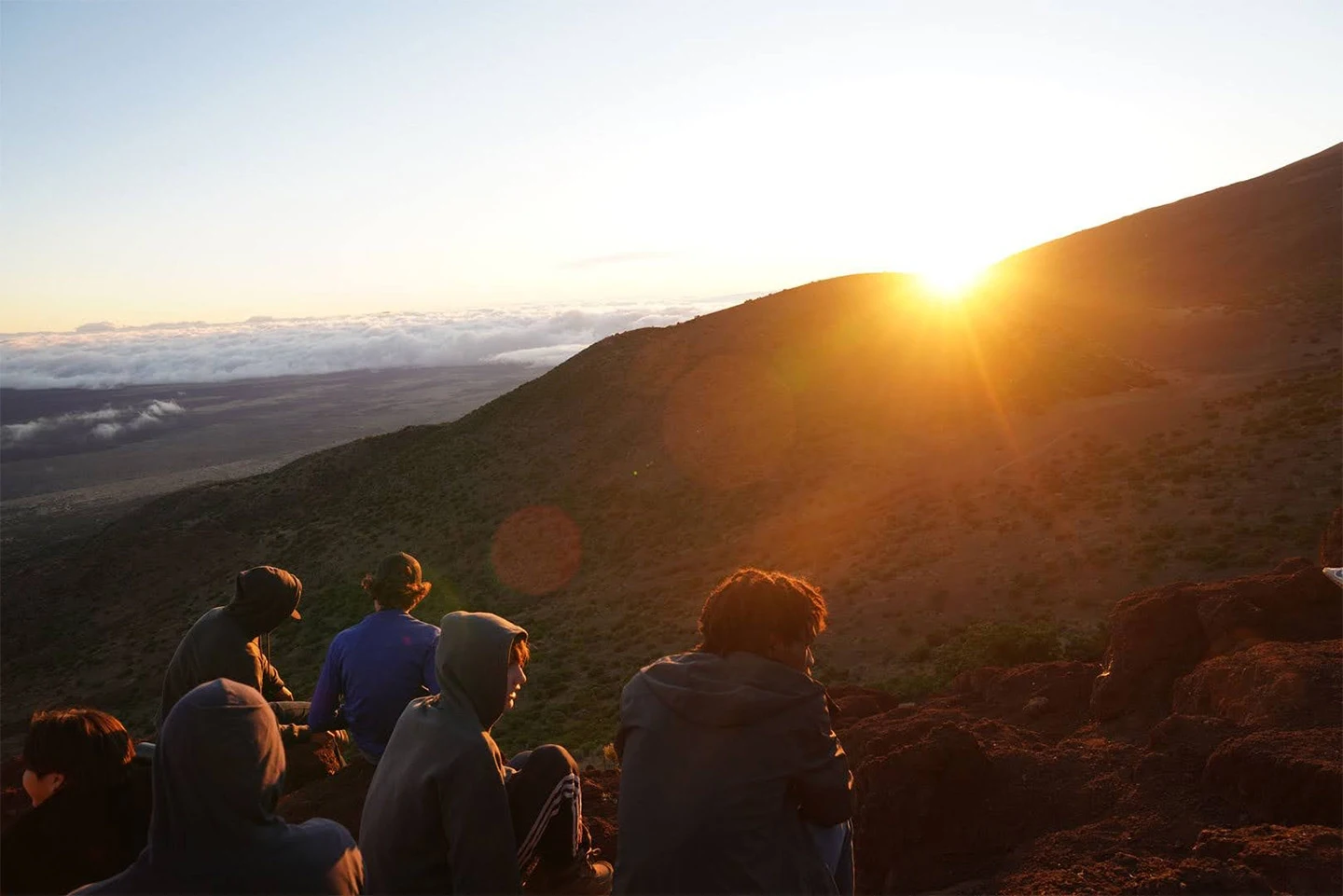 Image of sunset over a volcano while on another volcano